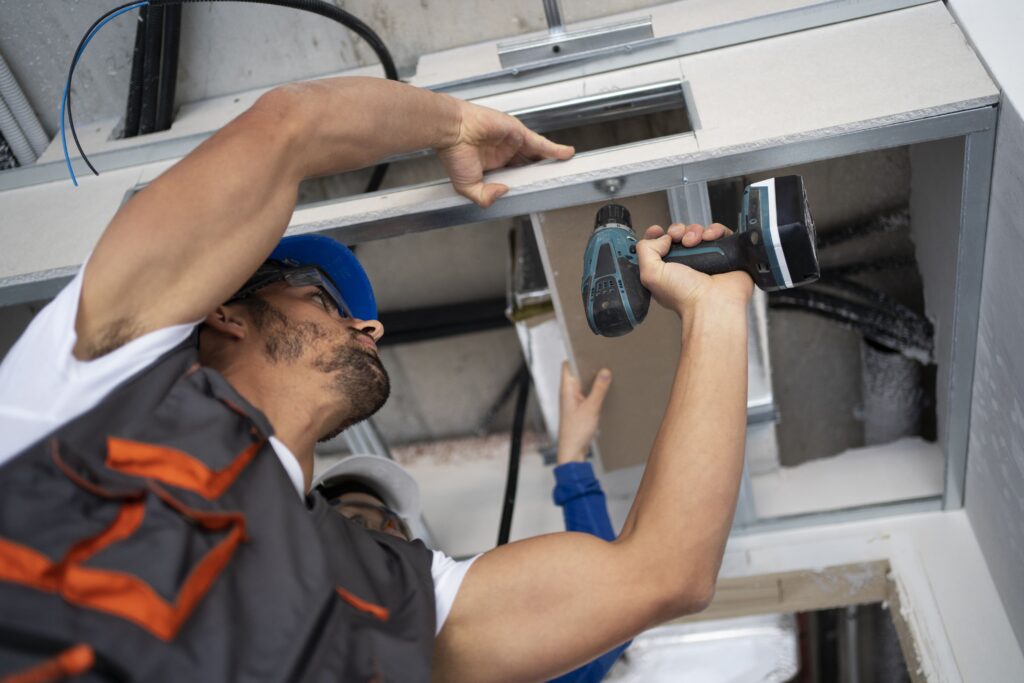 low-angle-people-working-with-drill-min
